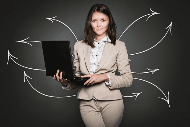 woman in suit holding computer