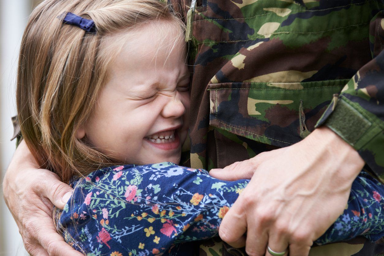 cute little girl tightly hugging man in military uniform - preserving parental rights